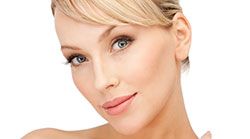 Beautiful grey eyed blonde woman smiling.